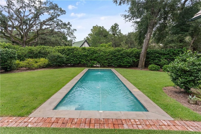 view of swimming pool featuring a lawn