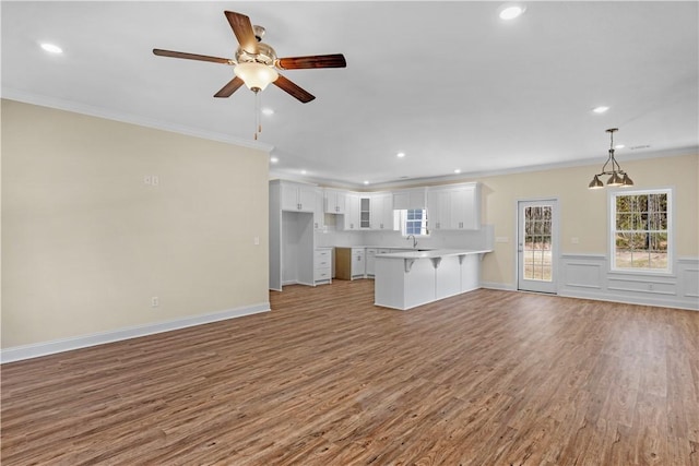 838 Old Ccc Rd, Brunswick, GA 31523 - unfurnished living room with ceiling fan, light wood-type flooring, and ornamental molding