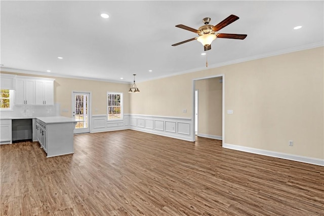 838 Old Ccc Rd, Brunswick, GA 31523 - unfurnished living room with hardwood / wood-style floors, ceiling fan, and ornamental molding