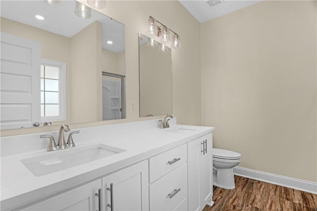 838 Old Ccc Rd, Brunswick, GA 31523 - bathroom featuring hardwood / wood-style flooring, vanity, and toilet