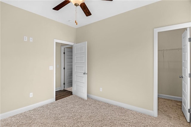 838 Old Ccc Rd, Brunswick, GA 31523 - unfurnished bedroom featuring a walk in closet, carpet floors, a closet, and ceiling fan