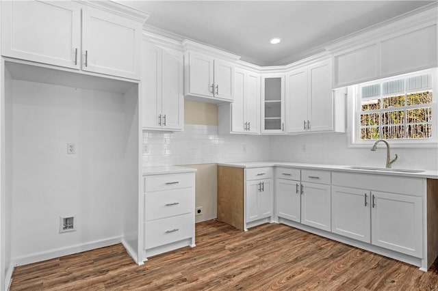 838 Old Ccc Rd, Brunswick, GA 31523 - kitchen with white cabinets, tasteful backsplash, sink, and hardwood / wood-style floors