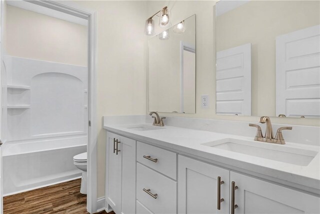 838 Old Ccc Rd, Brunswick, GA 31523 - bathroom with hardwood / wood-style floors, vanity, and toilet