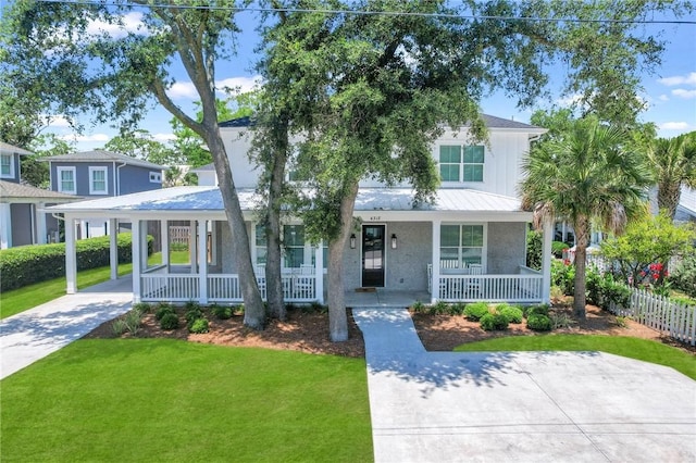 view of front facade with a front yard, a porch, and a carport