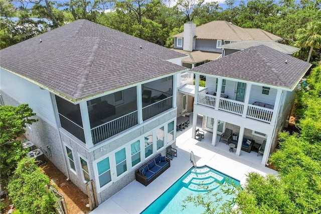 back of house featuring a balcony and a patio