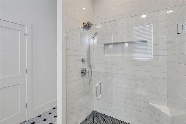 bathroom with a shower with door