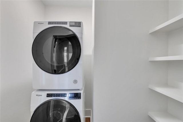 clothes washing area with stacked washer and clothes dryer