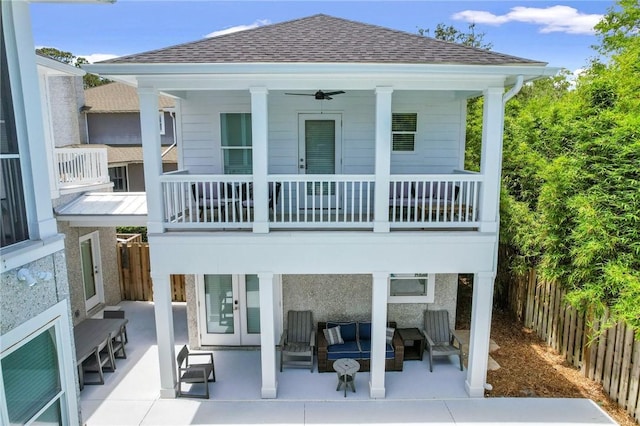 back of property featuring french doors, an outdoor hangout area, ceiling fan, a balcony, and a patio area