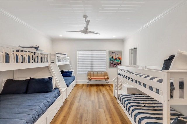 bedroom featuring ceiling fan, light wood-type flooring, and ornamental molding