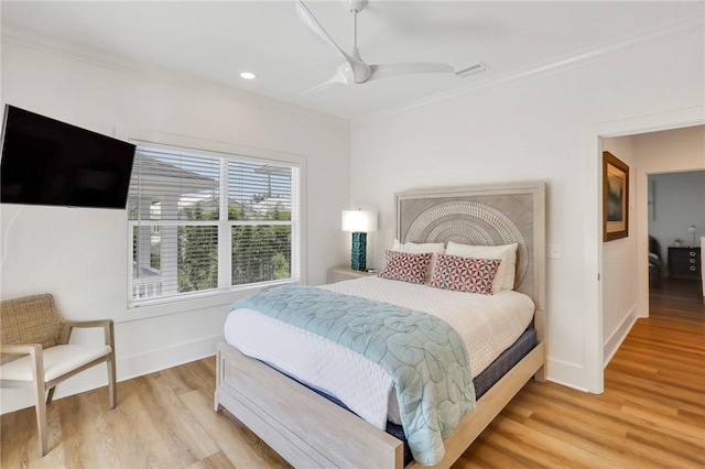 bedroom featuring light hardwood / wood-style flooring, ceiling fan, and ornamental molding