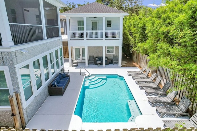 exterior space with outdoor lounge area, a sunroom, a fenced in pool, ceiling fan, and a patio