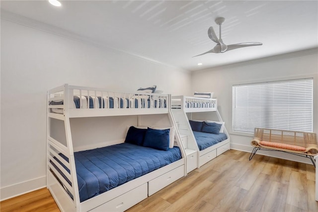 bedroom with hardwood / wood-style floors, ceiling fan, and ornamental molding