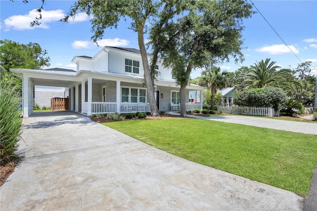 view of front of home with a carport, covered porch, and a front yard