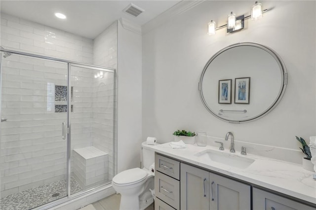 bathroom featuring vanity, toilet, an enclosed shower, and ornamental molding