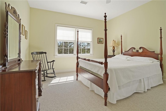 bedroom featuring baseboards, visible vents, and light colored carpet