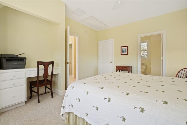 bedroom featuring light carpet and ensuite bath