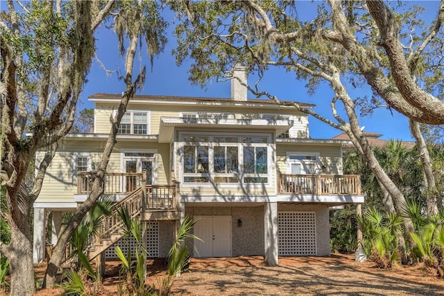 view of front of property with a chimney, stairway, and a deck