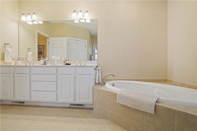 full bathroom featuring double vanity, visible vents, tile patterned floors, a sink, and a bath