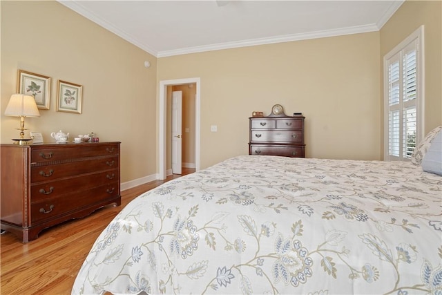 bedroom with baseboards, light wood-type flooring, and crown molding