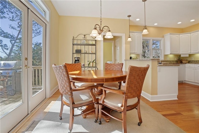 dining room featuring a chandelier, recessed lighting, baseboards, french doors, and light wood-type flooring