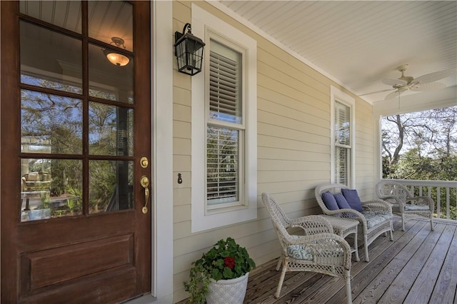 view of exterior entry featuring a porch and a ceiling fan