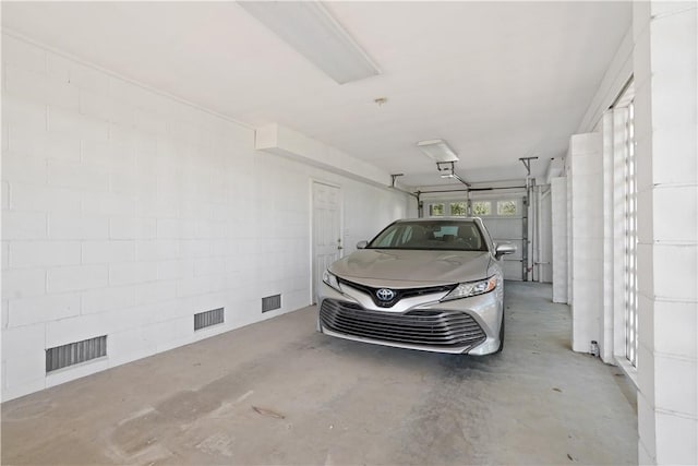 garage featuring concrete block wall and visible vents