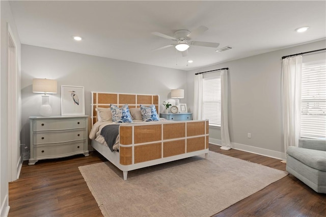 bedroom with ceiling fan and dark wood-type flooring