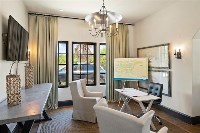 living area with a notable chandelier and dark hardwood / wood-style floors