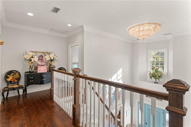 corridor featuring dark hardwood / wood-style floors, crown molding, and a chandelier