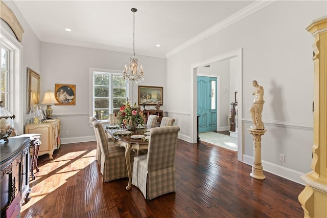 dining room with dark hardwood / wood-style flooring, ornamental molding, and a notable chandelier