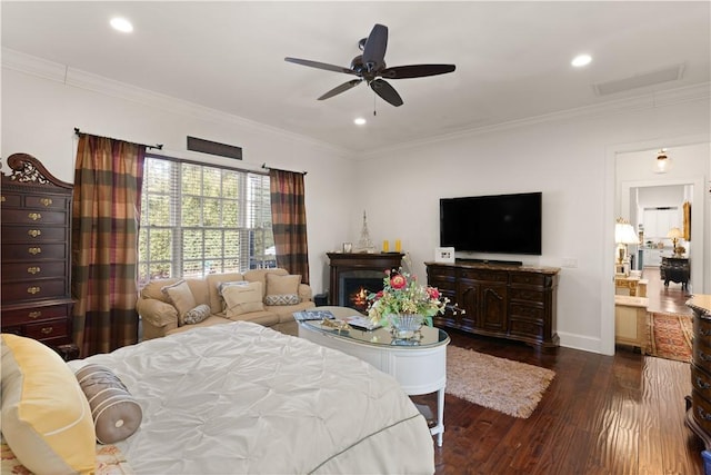 bedroom featuring ceiling fan, dark hardwood / wood-style flooring, and crown molding