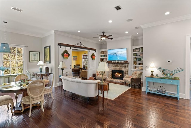 living room with dark hardwood / wood-style flooring, ornamental molding, and a brick fireplace