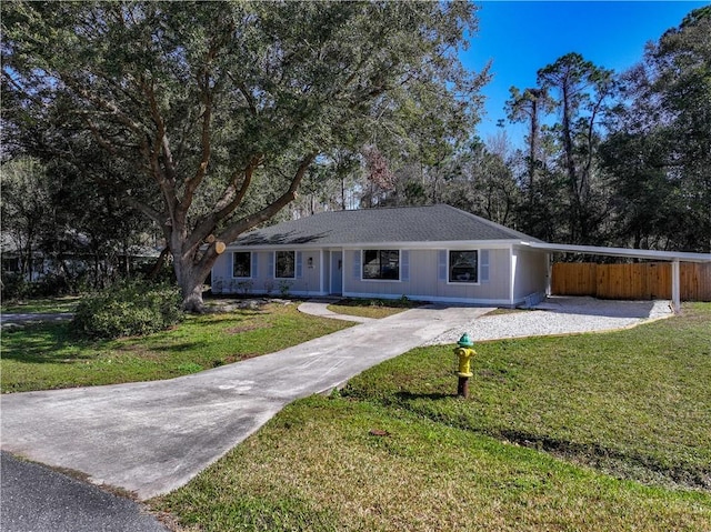 ranch-style home with a carport and a front lawn