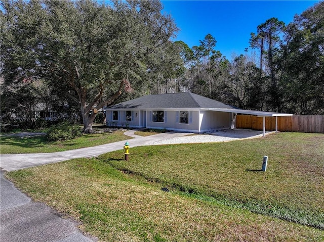 ranch-style home featuring a carport and a front yard