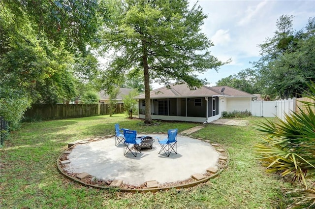 30 Bridgewater Way, Brunswick, GA 31525 - view of yard featuring a sunroom, a fire pit, a patio area, and a gate
