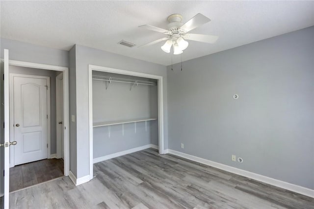 30 Bridgewater Way, Brunswick, GA 31525 - unfurnished bedroom featuring a closet, wood finished floors, baseboards, and ceiling fan