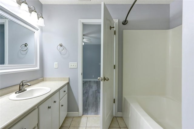 30 Bridgewater Way, Brunswick, GA 31525 - bathroom with tile patterned floors, vanity, baseboards, shower / tub combination, and ceiling fan