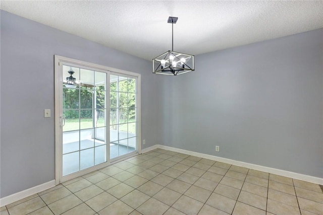 30 Bridgewater Way, Brunswick, GA 31525 - spare room featuring a chandelier, baseboards, a textured ceiling, and light tile patterned flooring