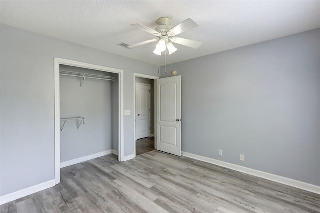 30 Bridgewater Way, Brunswick, GA 31525 - unfurnished bedroom with wood finished floors, a closet, baseboards, and a ceiling fan