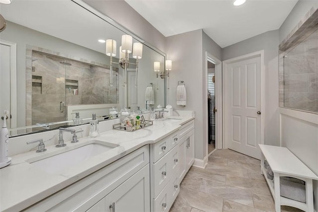 full bath with double vanity, recessed lighting, a stall shower, and a sink