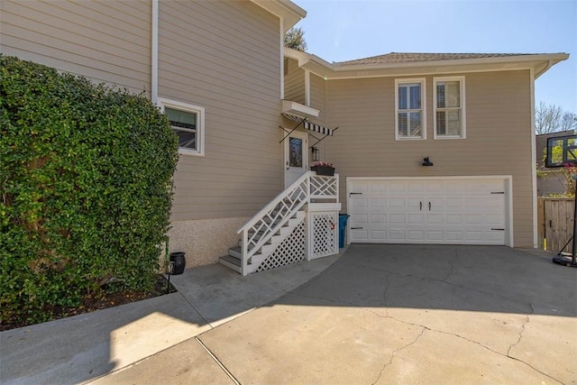 exterior space with concrete driveway and a garage