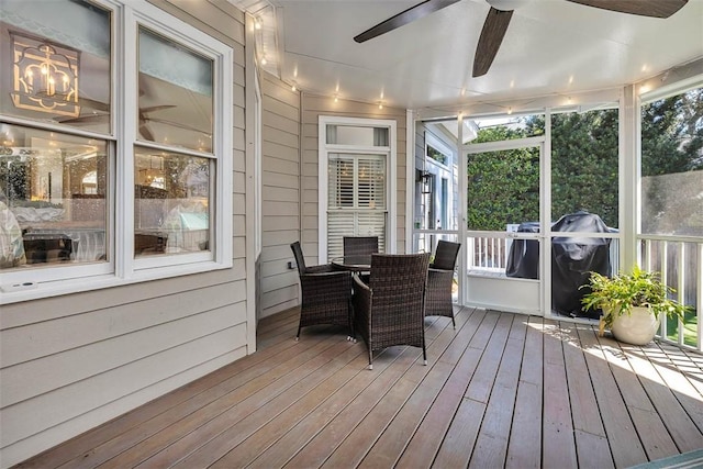 sunroom with a healthy amount of sunlight and ceiling fan