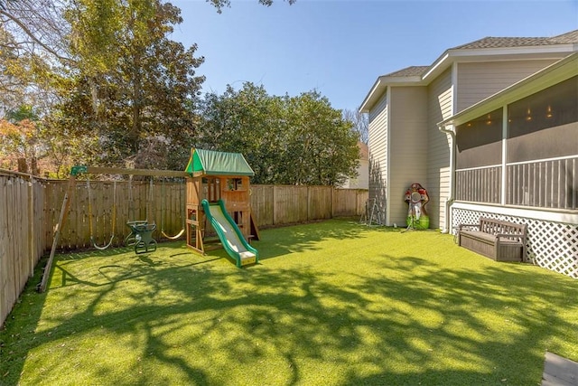 view of yard featuring a fenced backyard and a playground