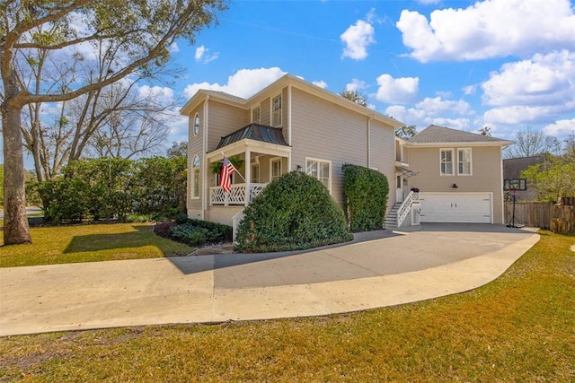 view of front of house with concrete driveway, a balcony, a garage, and a front yard