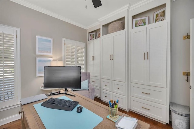 home office featuring baseboards, dark wood-type flooring, ceiling fan, and crown molding