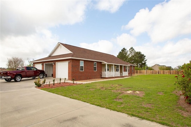 5604 Woodstone Dr, Blackshear, GA 31516 - view of front of property with a front yard, an attached garage, a porch, fence, and brick siding