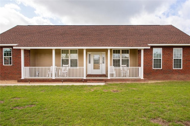 5604 Woodstone Dr, Blackshear, GA 31516 - ranch-style house featuring a porch, roof with shingles, a front yard, and brick siding
