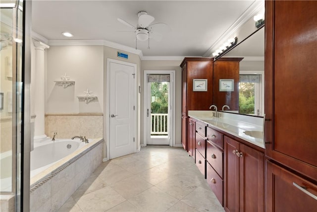 bathroom featuring ornamental molding, vanity, a relaxing tiled tub, and a healthy amount of sunlight