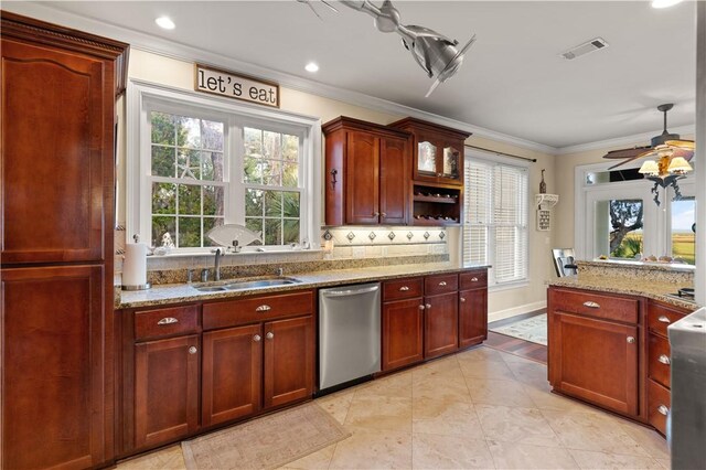 kitchen with light stone countertops, ceiling fan, crown molding, sink, and dishwasher