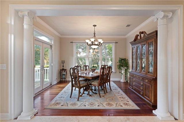 dining room featuring a chandelier, french doors, dark wood-type flooring, and ornamental molding